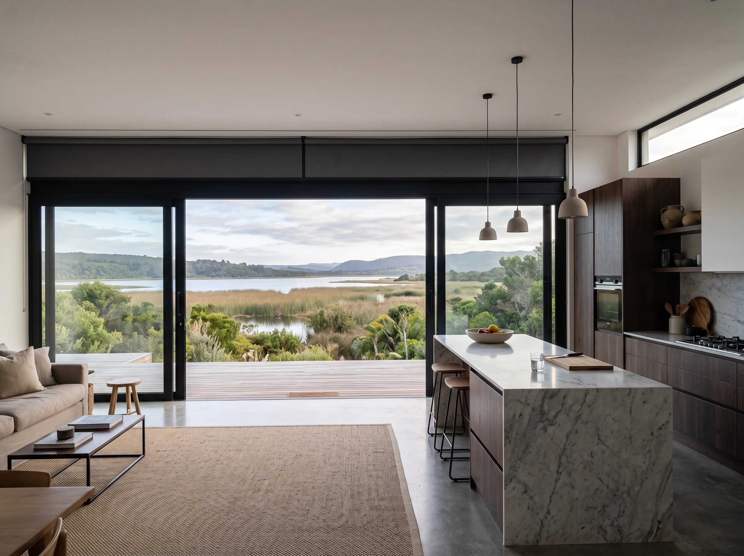 Roller blind concealed in a recessed ceiling pelmet above kitchen glazing in a Wilderness home